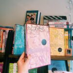 Alice Oseman Instagram - Out today… the special edition hardback of Heartstopper Volume 2!!! Soooo in love with how these three books look together. This one contains one of my oldest mini comics, ‘Flower Shop’! You can buy these special editions from most UK book retailers! 🌸