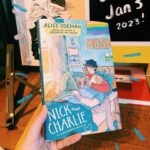 Alice Oseman Instagram - My novella NICK AND CHARLIE is out in the US/Canada in hardcover on Jan 3rd 2023 and I finally have a copy of it!!! I am actually obsessed with how this cover turned out. Perfect snuggly cosy Nick and Charlie vibes!!! ☀️🌙 You can preorder now from most book retailers!