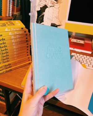Alice Oseman Instagram - My novella NICK AND CHARLIE is out in the US/Canada in hardcover on Jan 3rd 2023 and I finally have a copy of it!!! I am actually obsessed with how this cover turned out. Perfect snuggly cosy Nick and Charlie vibes!!! ☀️🌙 
You can preorder now from most book retailers!