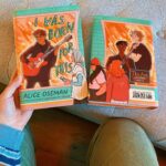 Alice Oseman Instagram - I WAS BORN FOR THIS is out now in the US and Canada!!! I adore this book and I had so much fun writing it, and now, four years later, it returns with a cover designed by me!! The more time that goes on, the more I see of real person fandom behaviour, and the more I’m introduced to the world of TV and celebrity, the more thoughts I have about these characters and this story and where it could lead. Maybe someday I’ll get to return to them! But until then, here it is, including a bonus short story I wrote early this year about Rowan and Lister called GHOSTED. I hope you enjoy it!! 🧡🎸🌧