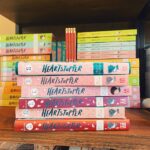 Alice Oseman Instagram - So I have a little surprise for you… on February 2nd, @teambkmrk are publishing the first of a set of gorgeous Heartstopper hardback editions!!! These won’t be limited in number so if you can order from the UK, you should be able to get one! Volume One contains one of my old mini-comics, ‘The Dream’, which you may have read if you follow the comic online. It’s out Feb 2nd and you can preorder now from Waterstones or other UK book retailers! 🍂 I feel very lucky that there are so many different editions of Vol 1 now 💖