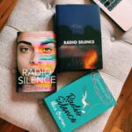 Alice Oseman Instagram - Introducing the last of my redesigned US editions… RADIO SILENCE! It’ll be rereleased in hardcover on December 26th 2023 by @harperteen with an exclusive letter from me inside and a cover illustrated by me! And you can preorder now from most US book retailers! Radio Silence has such a special place in my heart and I remain so so proud of this story… it truly feels like a representation of who I am as a human (or who I was… I guess?) I wrote it while I was at university, and dealing with that ‘second book syndrome’ made this story a huge challenge, but somehow I created something that made my heart sing and still does. I hope I can someday rediscover the passion I felt while writing this story 💙 It has been such a joy to illustrate covers for my old works and I am so deeply proud of this final one! Can you spot all the references to my other works? ♠️🍂🪽💜