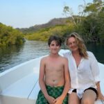 Alicia Silverstone Instagram - Still thinking about our bioluminescence boat trip experience… it was magical! 🛥️ Bear has decided he loves boats… and so does mama 😂🥰 We enjoyed the relaxing beautiful ride and then bopped around in the ocean bathtub for an hour while we watched the sun go down. Once it was dark we took the boat to the spot for the bioluminescence. It was so wonderful. I felt like a child watching my skin glow like magic. ❤️