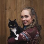 Amber Marshall Instagram – I recently passed the 1 Million followers mark on Instagram and it got me thinking about the content I’ve posted over the past 11 years… 
I have never been big on “selfies,” or photos of what I’m up to, but I do love sharing my farm, and the animal friends that adopt this space with us. 

The very first post I made on this account back in December 2012 was of our cat “Turner Valley” curled up on my bed. 📸 I had Shawn take this photo of me with her today to give an honourable mention to this sweet old kitty. 
“Turner Valley” was a stray I brought home in June of 2010. Heartland was filming in the town of Turner Valley and there was a litter of kittens born in an old storage shed in town. After confirming with the owners of the property that the cats were in fact strays… I set out on a mission that day to give one a good home. *For anyone out there who’s tried to catch eight-week-old untouched, stray kittens, it can be quite the challenge!! They are feisty little things and put up a good fight. After obtaining some thick leather gloves from our costume department I set out with a towel and was able to grab this little black and white hissing ball of fluff. I named her after the town she was born in, and took her home to begin gaining her trust. 
Turner has never been a cuddly cat, and prefers the company of dogs to humans or other cats, but for 14 years she has had a warm bed to sleep in and a full tummy. Her best friend was our old shepherd, Remi (yes from Heartland) who we brought home the same summer. They bonded instantly and Turner would always be the first to run to Remi and greet her, rubbing all over her and purring loudly. As soon as Remi found a good place to take a nap, Turner was there cuddled beside her. (Story too long for this post and continued in comments)

Thanks for reading this #MarshallSundayStory! Any requests for next weeks Animal Story? 😊

To see more photos and posts of Miss Turner Valley scroll through or click here: #AmbersCatTurner
