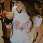 Amber Marshall Instagram - Coming soon ✨ Introducing @amber_marshall_farm newest animal t-shirt to add to your collection. Find the Phoenix shirt and other new items on our website tomorrow, January 23rd, at 12pm MST. Mark your calendars! 😊