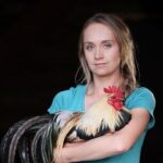 Amber Marshall Instagram – This week I decided to go with my main man of the chicken coop for my #MarshallSundayStory please put your hands together for, Phoenix the rooster. 

Phoenix is not just any ordinary rooster. Not only has he travelled across the country to star in a commercial, but he also has spent far more time living inside our home than your average farmyard bird. Phoenix was one of many chicks that I purchased in the spring of 2019. Being smaller in size, he was instantly targeted by the flock and picked on. One day, I went out to find him badly beaten by the other members of the coop. I scooped him up and decided that he needed to come spend some time in the house recovering. He became so comfortable in the house and friendly with us, he stayed far past his welcome. Over the next couple years Shawn and I moved and started building at our new property. We didn’t have a barn or a chicken coop so again, Phoenix (who at the time was the only bird we had) made himself at home, living in our little cabin. He would wander around the yard during the day, and in the nice summer months would sleep on our front porch. 

When winter came I set up an area for him in the cabin… but for those who have been around roosters, know that their early morning crowing can be deafening. We soon put a stop to this as our cabin is only one room and it echoed quite loudly each morning. 

By this time our barn was nearly finished anyway so I moved him to his own spot out there and purchased 4 Americana (a breed of laying hen) chicks to keep him company. 

Phoenix has been around for five years now and is definitely the king of his castle now. His 4 ladies are still doing well and we have since built them a coop of their own. This rooster has been more than just a bird to us and I thank him for being such a special member of our family. 

#AmbersRoosterPhoenix To view more Animal Stories click #MarshallSundayStory
