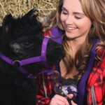 Amber Marshall Instagram – #MarshallSundayStory: Last week I told you the story of how my cat Turner came to live with me. This week, (after many requests) we will learn more about #BettyTheAlpaca who lived with us for a decade before she crossed the rainbow bridge. 

It was the summer of 2013 and I was at a ranch with my friend @KatieConnolley looking at some horses that were for sale. There was a lone alpaca there, so asked what her story was. The owner said he didn’t know how old she was, or much about her, as she had been left behind from a previous herd. He then said, “If you want her she’s yours.” 

I had no experience with llamas or alpacas but something about her just made me want to bring her home. She was not tame, and we had to wrangle her into a small pen, then rope and tackle her. I put an old t-shirt over her face to keep her calm, then we lifted her into the backseat of my truck – we hadn’t brought a trailer, so I sat holding her while my friend Katie drove us home (see last photo that was taken when we arrived home). 

I decided to turn her out with my cows so she wasn’t alone, and instantly she loped over to the young calves and started grooming them. She became Nanny Betty from then on. She took her job so seriously she would never let the calves out of her sight. My moma cows began trusting Betty, and would leave their calves with her for hours while they went out further to graze. 
Over the years Betty really warmed up to me. She even learned how to be haltered and walk nicely while being led. I miss Betty, as do my cows, and I’m not sure I will ever find another alpaca like her. ❤️

🦙 Story too long for this post, I have continued in the comments. 

See more of Betty on Instagram here: #BettyTheAlpaca