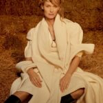 Amber Valletta Instagram - “I turn 50 this February, meaning I’ve worked in fashion for 35 years, and I’ve been a sustainability advocate for more than 20 of those, but in 2023 I hit a wall, mentally and physically,” confesses @AmberValletta. “The news just felt relentlessly bad – environmental and otherwise. I knew that, if I was ever going to get back on my feet, I needed to find a more sustainable approach to sustainability work.” In the January 2024 issue of #BritishVogue, the model and climate advocate reveals her path towards a more conscious future – and how fashion is following her. Click the link in bio to read the interview and see the full story in the new issue, on newsstands Tuesday 19 December. #AmberValletta photographed by @CharlotteMWales and styled by @PoppyKain, with hair by #ShingoShibata, make-up by #KanakoTakase, nails by @TrishLomax, set design by @MaxBellhouse, movement director by @EricVonChristison and production by @FaragoProjects. [Image one shows Amber Valletta, a white woman, from the knees up, sitting in front of a haystack in what appears to be a barn. She looks directly at the camera, her blonde hair loosely tied up, and wears a white mid-length dress underneath a white cape with a white scarf tied around her neck. A large gold pendant, roughly the shape of a horseshoe, hangs at her sternum on a leather chain. Image two shows a full-length portrait of Amber Valletta, a white woman, in a clearing, a forest visible in the background behind her, looking directly at the camera. She is standing with her legs slightly splayed and wears a wide-brimmed dark brown hat, a ribbon tied around its crown. She has a pair of khaki trousers on, while a light pink collared shirt peeks out of the top of her brown trench coat, whose belt is tied insouciantly at her waist. Image three shows a full-length portrait of Amber Valletta, a white woman, standing in front of a pile of kindling and firewood. She wears a quilted floral sleeveless coat liner with an oversized zip over a silver metallic gown. The wind is blowing locks of her shoulder-length blonde hair across her face, and her right arm rests casually on a piece of wood.]