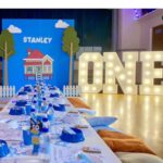 Amy Hart Instagram - This Episode Of Bluey Is Called Stanley’s First Birthday 🎂 💙🩵 The best time for my little boys first birthday 🎁 Theme:I looked on Pinterest and sent @everylastdetail_x a reeeally long voice note and as always they delivered!!! Even down to themed waters, biscuits from @thecupcakecollectionx , dog bowls instead of plates and little bone name tags 🥲. Roll on my UK hen do!! Food: I got pizzas for the adults, lots of different cans of drink and my Nan brought some cupcakes 🤣 For the babies I just went online and ordered so so many @kiddyliciousuk snacks. Felt this was the best zero waste option as now our cupboard is stocked with the ones we didn’t use!! My mum also did a tray of sandwiches and a tray of chicken dippers and sausages. Activities: We used two local family run companies, @rentyoureventsussex for the bluey soft play and DSH Leisure for the bouncy castle. I had DSH castles my whole childhood so really special that we can now use them for Stanley!! We also had @one_stop_partyshop come along with Bluey herself! I tried to book the full 2 hour party but they recommended that we just did 30 mins and it was fab! Games, singing and dancing and a meet and greet! I also used to do panto with Blueys party assistant so it really was the most Worthing party you can get 🤣 Cake: We used @kellyscakes_ We had white chocolate and raspberry (Stanley’s faves) and it was sooo good! Also very reasonably priced and I finally managed to order a cake for the size of the guest list and not for the feeding of the 5000!! Outfit: @indielledesigns 💙 my go to for seasonal clothing! Party Boxes: I had seen adopt a floppy on Pinterest so asked @my1styears if we could do a bulk order of the bunnies, they took it extra and gifted everyone a personalised denim jacket 😢 I also bought a box of bubble wands off Amazon and each child got a little book too! (Little libraries, also from Amazon!) (m1y also gave me a discount code which is AMYHART10 xx)