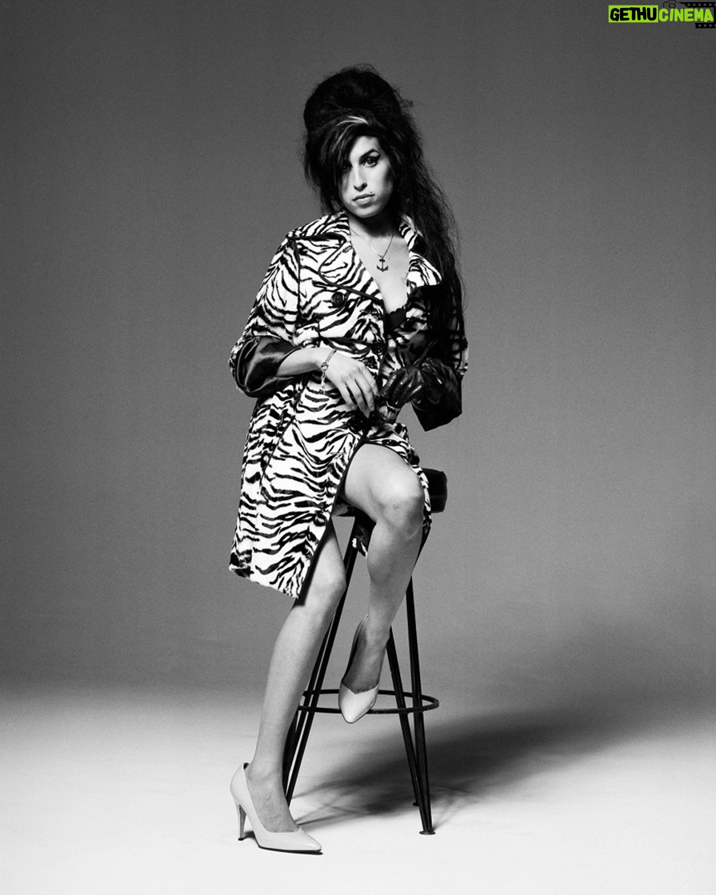 Amy Winehouse Instagram - Amy was photographed by @brookenipar in 2007, showcasing her unique style in a gorgeous zebra coat. 🖤