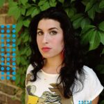 Amy Winehouse Instagram - Amy photographed in 2003, with big red hoop earrings and a rising star in her eyes. 🍃❤️ 'Recognise my every sound; there's nothing new to learn’ 🤍 📸 Eva Vermandel