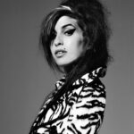 Amy Winehouse Instagram – Amy was photographed by @brookenipar in 2007, showcasing her unique style in a gorgeous zebra coat. 🖤