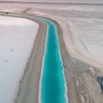 Andréane Chamberland Instagram – This man-made canal contains a concentrated brine solution that is not suitable for human consumption. This canal is a part of potash mining, which is present here due to the abundance of salt.
The mine produces potash, which is a potassium-containing salt used in fertilizer. Canals transport this concentrated brine solution to evaporation pools. It is strongly advised not to swim in this area. 
#potash #utah #utahphotography #utahphotographer #utahunique #utahgram #utahtravels #utahlife