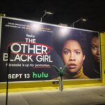 Ashleigh Murray Instagram - We were just strolling along at 10p and found a massive, massive wall with my face on it 😭 @theotherblackgirlhulu is still available to stream right now!