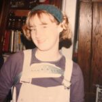 Ashley Johnson Instagram – My sister has been going through old pictures and just sent me this gem. I had to wear a back brace for 3 years, 22 hours a day (would remove for showers or baths and PE Class/sports), starting at 12 years old. Because of this, I wore overalls to hide it and had them in just about every color and material. Denim at the beginning of the week, corduroy on Thursdays and Fridays and on weekends or school dances, VELVET. Also, I very much enjoyed wearing that headband. It was an accessory that came with a terry-cloth robe from Victoria’s Secret. The intended purpose for said accessory was to hold your hair back while you wash your face. But I wore it everyday and felt VERY scandalous wearing something from Victoria’s Secret. I made sure to tell everyone where it was from. It was my SEXY item of clothing. #VictoriasSecret