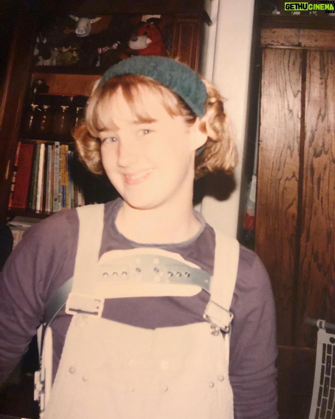 Ashley Johnson Instagram - My sister has been going through old pictures and just sent me this gem. I had to wear a back brace for 3 years, 22 hours a day (would remove for showers or baths and PE Class/sports), starting at 12 years old. Because of this, I wore overalls to hide it and had them in just about every color and material. Denim at the beginning of the week, corduroy on Thursdays and Fridays and on weekends or school dances, VELVET. Also, I very much enjoyed wearing that headband. It was an accessory that came with a terry-cloth robe from Victoria’s Secret. The intended purpose for said accessory was to hold your hair back while you wash your face. But I wore it everyday and felt VERY scandalous wearing something from Victoria’s Secret. I made sure to tell everyone where it was from. It was my SEXY item of clothing. #VictoriasSecret