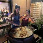 Ashley Park Instagram - when your only sibling is marrying the man of her dreams and wants a bachelorette party in Barcelona, YOU DO A BARCELONA BACHELORETTE… aperol spritz-themed, homemade paella-filled, with all her awesome friends 🍹🥘👰🏻🌞🥂 @audreyhehepark @kimptonvividora