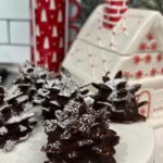 Autumn Calabrese Instagram - The perfect holiday dessert!!! Had to see if I could make these brownie pinecones w/ Fixate avocado brownies. They came out so good and there a healthier option than the box mix. 🎄 GF VG 1⁄2 cup gluten-free all-purpose flour (preferably Bob’s Red Mill® All- Purpose Baking Flour, red label) 1⁄4 cup unsweetened cocoa powder semisweet 2 cups chocolate chips 1 Tbsp. extra-virgin organic coconut oil 1 cup mashed avocado 1⁄2 cup 2 Tbsp. pure maple syrup 2 large eggs 2 tsp. pure vanilla extract 1 dash sea salt (or Himalayan salt) 1. Preheat oven to 400° F. 2. Line a 9 x 12-inch baking dish with parchment paper, allowing it to come up the sides of the dish. Coat with cooking spray. Set aside. 3. Whisk together flour and cocoa powder in a medium mixing bowl. Set aside. 4. Place a double boiler over low heat with water 1-inch deep in bottom. Add chocolate and coconut oil to top of double boiler, stir occasionally until melted. Set aside. 5. Place avocado, maple syrup, eggs, extract, and salt in blender; cover. Blend until smooth. Transfer to a mixing bowl. 6. Stir melted chocolate into avocado mixture. Fold in flour mixture, adding 1⁄3 of mixture at a time, until fully combined. 7. Spread mixture evenly in prepared baking dish. Bake for 13 to 15 minutes, or until firm on top. 8. Allow to cool completely in baking dish Use a small ice cream scoop or spoon to scoop out brownie mixture, roll into pinecones shape. A little more round at the bottom, narrow at the top. Place on parchment paper Stick sliced almonds in starting at the base and working your way up. Place in freezer for 30 min to harden slightly. Melt 1 cup semi sweet chocolate chips with 1 tsp coconut oil. Drizzle over pine come brownie, be sure to get the bottom of the almonds. Place back in freezer for 30 more min to harden chocolate. Dust with powdered sugar.