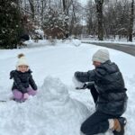 Caroline Manzo Instagram - Building a snowman with mommy @laurenmanzo - its a tiny snowman but she’s one happy little girl. ❤️❤️⛄️❄️