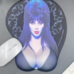 Cassandra Peterson Instagram - Give your wrists the rest they deserve with our @therealelvira mouse pad. 🖱️💥 #kreepsville #kreepsville666 #Elvira #elviramistressofthedark #mousepad #officegoth #gothichomewears #wristrest #gothicoffice #gothhome