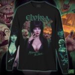 Cassandra Peterson Instagram - Are you a 🐺🎃💀 or 🦇? All new officially licensed ELVIRA collection is here, and includes this MONSTER MASH long sleeve featuring some frightening friends, with the Queen of Halloween! 👀 Open pre-order continues all week. Guarantee your size before it’s too late!