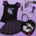 Cassandra Peterson Instagram - Channel your inner mistress of the dark with our new @therealelvira Shoulder Top! 🖤💜 Where would you rock this paranormal purple look? Model: @victoriavenin #kreepsville666 #kreepsville #Elvira #gothstyle #purpleoutfit #creepycute #gothfashion #spookyvibes #elviramistressofthedark #horrorhostess 🕷️✨