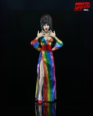 Cassandra Peterson Instagram - ANNOUNCEMENT! 🏳️‍🌈 🖤
➖
Elvira - Over the Rainbow Elvira 8” Clothed Figure 
➖
Celebrate Pride Month with Elvira, Mistress of the Dark! The devilishly delightful Cassandra Peterson has played the part of Elvira for more than 40 years with grace, humor and more than a little camp. NECA is proud to present this “Over the Rainbow” Elvira figure, celebrating the horror and queer icon in a never-before-seen, sparkling rainbow dress for your collection. With an original tailored fabric gown, glittery ruby red heels, and a yellow brick display base, she’s definitely not in Kansas anymore! This fully articulated 8-inch action figure features new faceplate technology with two interchangeable expressions and hands, including brand new ones that allow you to recreate Elvira’s signature pose! She comes with a book accessory of Peterson’s memoir, “Yours Cruelly, Elvira”, and a double-sided flag with 10 stickers to customize and show your unique pride! 
➖
Available now on thenecastore.com, and shipping to your favorite NECA retailer in June!
➖
#Elvira #MistressoftheDark #Pride #OvertheRainbow #CassandraPeterson #NECA  #actionfigure