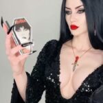 Cassandra Peterson Instagram - Never miss a touch-up with our @therealelvira coffin compact- a must-have for every gothic glam kit! 🖤✨ Model: @elisawiitch #kreepsville #kreepsville666 #elvira #gothicbeauty #coffincompact #elviramistressofthedark #gothglam