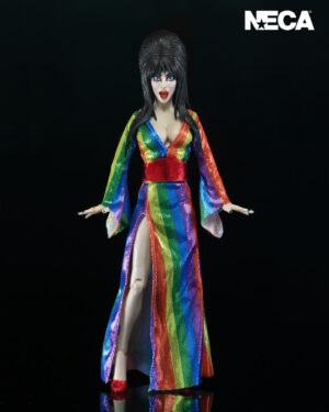 Cassandra Peterson Instagram - ANNOUNCEMENT! 🏳️‍🌈 🖤
➖
Elvira - Over the Rainbow Elvira 8” Clothed Figure 
➖
Celebrate Pride Month with Elvira, Mistress of the Dark! The devilishly delightful Cassandra Peterson has played the part of Elvira for more than 40 years with grace, humor and more than a little camp. NECA is proud to present this “Over the Rainbow” Elvira figure, celebrating the horror and queer icon in a never-before-seen, sparkling rainbow dress for your collection. With an original tailored fabric gown, glittery ruby red heels, and a yellow brick display base, she’s definitely not in Kansas anymore! This fully articulated 8-inch action figure features new faceplate technology with two interchangeable expressions and hands, including brand new ones that allow you to recreate Elvira’s signature pose! She comes with a book accessory of Peterson’s memoir, “Yours Cruelly, Elvira”, and a double-sided flag with 10 stickers to customize and show your unique pride! 
➖
Available now on thenecastore.com, and shipping to your favorite NECA retailer in June!
➖
#Elvira #MistressoftheDark #Pride #OvertheRainbow #CassandraPeterson #NECA  #actionfigure