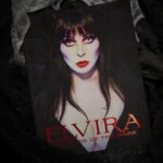 Cassandra Peterson Instagram - Who says you can’t judge a book by its cover? Especially when it looks this devilishly charming! 😈🖤 Curl up with a mug of something dark and Cassandra Peterson’s Best-Selling autobiography, ‘Yours Cruelly, Elvira’ … or if you’re more of a visual learner, Elvira’s Coffin Table Book! #elvira #elviramistressofthedark #cassandrapeterson #yourscruellyelvira #autobiography #bestsellers #bookstagram #books #coffeetablebooks #horror #halloween #halfwaytohalloween