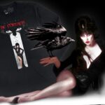 Cassandra Peterson Instagram - “It can’t rain all the time, but when it does, it’s best under a full moon.” Celebrate the 30th anniversary of ‘The Crow’ with a twist only the Mistress of the Dark could serve.🖤✨ Will you be watching the remake this summer or resurrecting the original? #elvita #elviramistressofthedark #elvirasbootique #thecrow