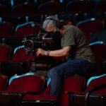 Chelsea Peretti Instagram – Director Chelsea Peretti (@chelsanity), #DOP Jonathan Furmanski (@kosherpork), and #Producer Deanna Barillari (@deannabarillari) take us #behindthescenes of #FirstTimeFemaleDirector, now streaming on @therokuchannel:

Chelsea: 
“The film is a handsome, yet unpretentious, documentary-style comedy. I didn’t want it to be overly lit or have bright sitcom colors. In my mind, a volunteer aspiring filmmaker in Glendale shot it for a small fee that could be afforded by a local theater. Still, I wanted to have moments emerge that suddenly would look more self-serious and dramatic a la Birdman.

A visual reference I wanted to explore was nature docs, which have heart, but also can make you laugh. The Muppets were also a fun visual reference, which Deanna brought to my attention.”

Jonathan:
“Chelsea and I wanted the film to feel a bit bigger in its ambition and scope. Many scenes had the entire main cast—nine people or more—and we didn’t want to just shoot singles of everyone, so those inspirations helped everything stay a little looser, a little more whimsical, and gave the cast more room to improvise. We sometimes just looked at a cute picture of meerkats standing around and used that to inspire the staging.
 
I wanted to work with Panavision on this film from the get-go because I knew they’d take very good care of us and their optics are just insanely good with almost limitless options.”
 
Deanna: 
“What I look for is the same in all areas: grounded artists with a strong work ethic, careful attention to detail and care no matter the budget. I get all of this at Panavision and Light Iron, which makes it easy to return to them time and time again. 

I laughed every day at this job—big belly laughs. Amy [Poehler] and Chelsea cared so much about the cast and crew and keeping a positive attitude on set. It was a joy.”

Chelsea:
“I have strong comedy opinions and tastes and have always had particular ideas about how funny performers around me should be used creatively, so there was always an interest in directing. I also found it extremely stimulating to think in such a layered and problem-solving way and learned a lot about how I would approach filmmaking in the future.”