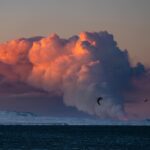 Chris Burkard Instagram – I jumped out of bed this morning for an early ski touring lap to catch sunrise… but much to my surprise I saw a warm glow radiating from the Reykjanes Peninsula and realized that a new volcano just erupted.  I texted my assistant @joelbarger_ from the top of the mountain –  who grabbed our long lens and nailed the shot just looking over the bay not far from our new studio. It’s moments like this in Iceland that continue to amaze me… a juxtaposition of normal life and sometimes devastating elements, locals continuing their day like any other Thursday but a beautiful fiery chaos erupts less than 45 minutes away.