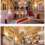 Chris Flores Instagram - Continuação post anterior… As escadas bifurcadas de mármore do hall de entrada da Ópera conduzem à grande escadaria, onde a experiência estética se torna ainda maior. Os dois lances de escada conduzem às entradas do térreo do auditório. Pinturas de Mór Than adornam os nove retângulos dos caixotões dourados que embelezam o teto espelhado acima da escadaria principal. Os tópicos destes são o Despertar da Música e o Poder da Música. Os retângulos alongados nas laterais representam a cena principal da disputa entre Apolo (tocando lira) e Mársias (tocando flauta), intitulada O Julgamento de Tholos. De acordo com a história mitológica, o deus do rio Tolos decidiu que Apolo vencera a disputa, e o sátiro pagou por sua insolência sendo esfolado. A pintura ao redor do lustre faz referências a Hera, Hades, Zeus e Poseidon. A lesene que corre ao longo da parede retrata três cenas ligadas a Orfeu: as pinturas de Mór Than mostram-no primeiro em frente à porta de entrada para o submundo, depois trazendo Eurídice do submundo e, finalmente, ilustram a sua morte. Representações alegóricas de Belas Artes e Arquitetura estão localizadas acima da entrada do Bar Feszty, sendo que este último contém os planos da Ópera. Continua no próximo post… 📷 @ricorreafoto