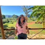 Chrissie Fit Instagram - Who would’ve pegged me as a guajira? Los paisajes de Cuba son una maravilla. The Cuban countryside is unreal. I recommend you go there and buy tobacco directly from the farmers. They are forced to give 90% of their crops to the government and only have 10% to sell themselves. It’s more authentic this way and you’re helping the farmer, who takes so much pride in growing their tobacco, fruits, veggies, and coffee. Btw, I did not know how to smoke a cigar. At the risk of losing my Cuban card, I will post in my stories 😅 #Cuba #Vinales #CuevaDelIndio #palenquedeloscimarrones #cubancountryside #ReturnToMyRoots #CubanHeritage #Cuban #Guajiro #Guajira