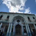 Chrissie Fit Instagram - While in Cuba, I visited the town where the Fit family was from, Guanabacoa. I met the few relatives we still have there, whom I’ve only ever spoken to through WhatsApp. They treated me with such love, kindness, and care. It was like I’d known them all my life. Thankfully, the woman who now lives in my family’s old home (pictured here) was happy to give us a tour inside. While the house has changed and deteriorated with time, I can still picture where my grandfather played dominos on the front porch and where the Christmas tree was set each year — in front of the three columns in the living room, now partially blocked by new stairs. I only cried like, five times. Picture Descriptions: 1 & 2. The Fit Family Home - Where my grandfather, grandmother, dad, uncle, great grandfather, great grandmother, great aunts, and great uncle lived (a total of 9 Fits!). 3. The living room 4. The back of the house 5. Some of my remaining family in Cuba 6. My uncle dressed as a ______ (any guesses?) and my grandfather (second from the right) with his friends 7. My dad when he was a baby in Guanabacoa 8. Cine Teatro Carral - The now abandoned movie theater where my grandfather watched what would become his favorite movie, King Kong 9. What was once the courthouse in Guanabacoa where my grandparents got married, now in ruins 10. My grandfather’s favorite niece, resembling my grandfather #Cuba #ReturnToMyRoots #CubanHeritage #Guanabacoa #FamilyHistory #FamilyHome #Family