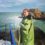 Christina Hendricks Instagram - Those of you who know me well, know I have a fear of the ocean. But bigger than that fear, is the fear of not doing something extraordinary because I’m too scared. So, I decided I would go to the 40 ft. In Dublin and jump into the Irish Sea. But before I could take my own steps, the ocean, in one dramatic wave , grabbed me from this rock and through me under, scraping my leg, plunging me under water with a mouth full of salt water as I was gasping for breath and then pummeling me over and over again with waves that made it almost impossible to swim back to land. But I did it. And it was exhilarating. I survived. And I might even do it again. But better planning next time…. I’m proud of myself. #40ft #dublin #irishsea