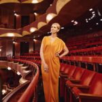 Cynthia Nixon Instagram - I 🧡 this cast!! Thank you to the @metopera for hosting us for a visit to the home of the opera wars seen in @GildedAgeHBO S2! In addition to working with our wonderful cast and crew, one of my favorite parts of #TheGildedAge is experiencing the history of my lifelong hometown 🗽🌃 through our show. New episode tonight…! ✨ Photos by @EmilioMadrid for @TownAndCountryMag Team Credits: @alicialombardini @itsmatin @rebekahforecast Fashion Credits: Dress: @zeromcornejo Shoes: @gianvitorossi Jewelry: @wempe Bag: @_thebellarosacollection Coat: @aleksandraviktor_