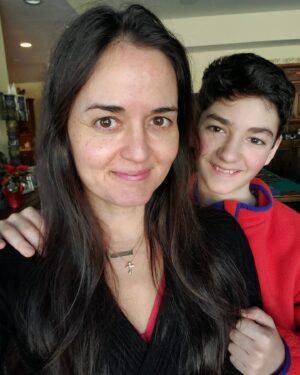 Danica McKellar Instagram - No makeup, no filter, just standing in front of a window taking a birthday selfie for you... and getting the best "interruption" ever. 🥰 #ThisIs49 #ilovebeingamommy 
.
.
Happy New Year, everyone!! Let's make it a year of renewed commitment to taking care of ourselves - lots of water, healthy food, moderate exercise - nothing crazy, just all the things we know are good to do. Because you know what? When we take care of our bodies, our bodies take care of us - including our mood! It's a great investment in ourselves - and you are worth the effort!! 🤗 (I'll be doing more yoga and stretching this year - it feels SOOO good and it so important for our bodies to function properly - link in my bio for my yoga DVD, "Daily Dose of Dharma." ❤️) 
.
.
On the spiritual side of things, continuing my faith journey, this year I'll be reading the Bible all the way through for the second time, using @thebiblerecap - it's not too late to join me, for anyone who's interested. 🙏
.
.
Sending you all the love in the world - Happy New Year! 🌟🎉
