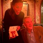 Davina McCall Instagram - This looks like I’m harassing a diner at the restaurant 😂😂😂 but I was harassing my besties hubby , nothing new there … been doing it for decades 😂😂😂😂…. I can’t think of a better way to celebrate than with them @mdlondon 🥳😍🥰 and our families … but Tilly and Bache you were really really missed … really really . But with us in spirit . What a day x thank you for all your messages . Congrats to all the other wonderful recipients we met today and all the wonderful people at Buckingham Palace who made it so special . Also @broadwicksoho for fantastic food and my flowers 🧡🩷💝 wow x going to sleep with a massive smile on my face . Btw @abigailrosewhite found me my wonderful dress by @rebeccavallance and fascinator by @camillarosemillinery and shoes by @ginashoesofficial
