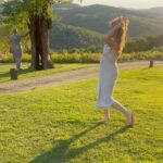 Denise Richards Instagram - It’s been a dream of mine & my husband’s to go to Tuscany. I was so lucky to shoot in Italy this past week so we decided to make a big trip out of it. Here we are Trying to capture the best pic & me looking ridiculous and my hair all crazy( we just went to the spa) I look at some of your photos and wonder who the hell is there to take them? Do you all travel with someone? Do you ask someone close by to shoot it? I’m so curious 😂 because most of you all that I follow your vacay pics looks really good!