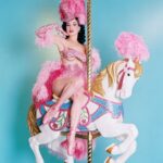 Dita Von Teese Instagram – The Carousel Horse ✨🎠✨
When @catherinedlish and I first debuted this act in 2001, as the new wave of burlesque was underway, it blew expectations among audiences and fellow entertainers. The top hat. The costume. The #carousel horse complete with shiny brass pole. Everything blindingly and colorfully twinkled with @swarovski ✨
Catherine’s costume was the most over the top she had done at the time. In my 2002 #Playboy cover story, I posed in my full “Carousel” act regalia, from plume to #pointe shoes, perched atop the twee horse. Alas, that #bedazzled beast went missing a few years later and we had to remake it. 
For Dita Las Vegas, three of the four jeweled horses now in my “stable” appear, side straddled by Von Teese Dancers in Jubilee archival costumes. 
🌟Dita Las Vegas has added even more shows! 🌟
March 27, 28, 29, 30
April 3, 4, 5, 6
April 10, 11, 12, 13
April 17, 18, 19, 20
April 24, 25, 26, 27
May 16, 17, 18
May 21, 23, 24, 25
May 29, 30, 31, June 1
June 5, 6, 7, 8
June 12, 13, 14, 15
Ticketmaster.com/ditavegas