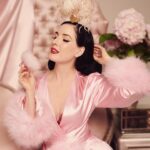 Dita Von Teese Instagram – ‘POULE DE LUXE’ 
This golden bird is available with or without feather plumes. These luxurious showgirl add-ons are removable and available in several different colors. Talk about a bird of a different feather…
🦢
@ditavonteese 
@dedwardsphoto 
Dressing gown @catherinedlish 

#ditaxhood #hoodlondon #ditavonteese #luxuryfashion #showgirl #burlesque