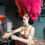 Dita Von Teese Instagram - Ready to make an entrance ✨ WWD got ready with @ditavonteese in Las Vegas! Photo 1: On the showgirl disc above the audience. Vintage Jubilee! showgirl headdress by Pete Menefee, costume by Michael Schmidt utilizing Swarovski Crystal. Photo 2: In my quick change dressing room, getting set to start the show. Photo 3: In Jenny Packham, posing with the car I drive out onstage… and sometimes down the Las Vegas Strip! Photo 4: Wearing Jenny Packham and posing with the Bob Mackie finale “Jewels” costumes Photo 5: My vanity area in my dressing room backstage at the legendary Jubilee Theater, which housed the last great Las Vegas showgirl revue. Report: @knowandtell 📸: @bfreedphoto