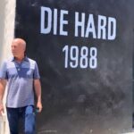 Emma Heming Instagram - Back in 2018 (when these videos and pictures were taken) we took Mabel and Evelyn to the Fox lot to peek at the archives as well as see the larger-than-life mural of their dad. This mural was unveiled in front of Bruce back in 2013 to commemorate Die Hard’s 25th anniversary. Today marks Die Hard’s 35th anniversary when it hit the screens and the rest is history. What Bruce has been able to accomplish in his career will never be lost on us. We are so proud of him 🤍