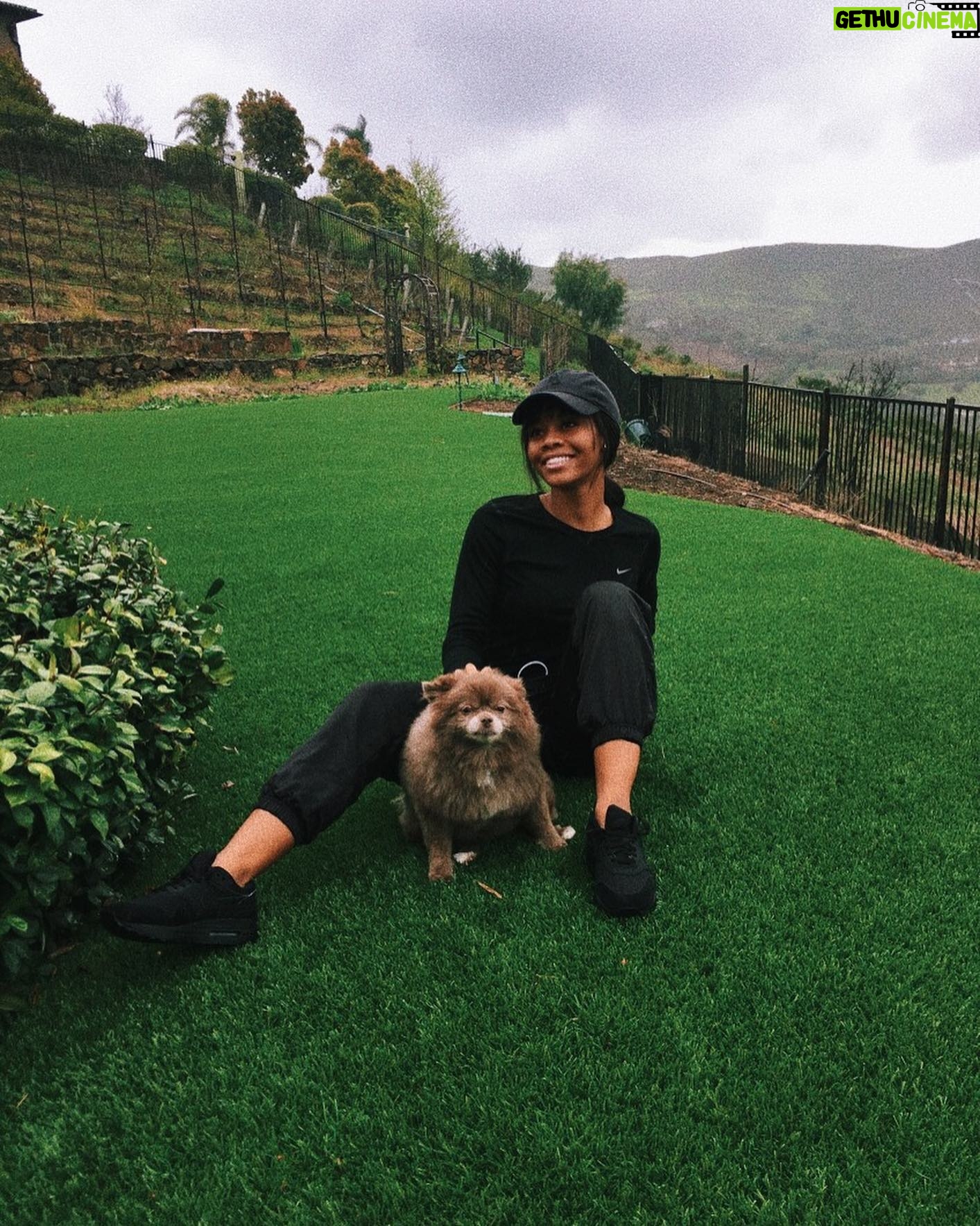 Gabby Douglas Instagram - hoping you all are safe and healthy, sending you all my love. also, cali was mad at me because we took the photo in the rain...