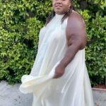 Gabourey Sidibe Instagram - Y’all about to get this look in about 30 different post over the next few months cuz I’m not going outside anymore. It’s not even about Covid. I just get hung over if I don’t get in the bed by 6pm. Anyway, Styled by @kellyaugustine and assisted by @couturemoments_ in a @nerecinacouture dress with @commedesgarcons @converse cuz my ankles ain’t ankling like they used to. And get into this eye makeup!! @tobyfleischman went OFF!