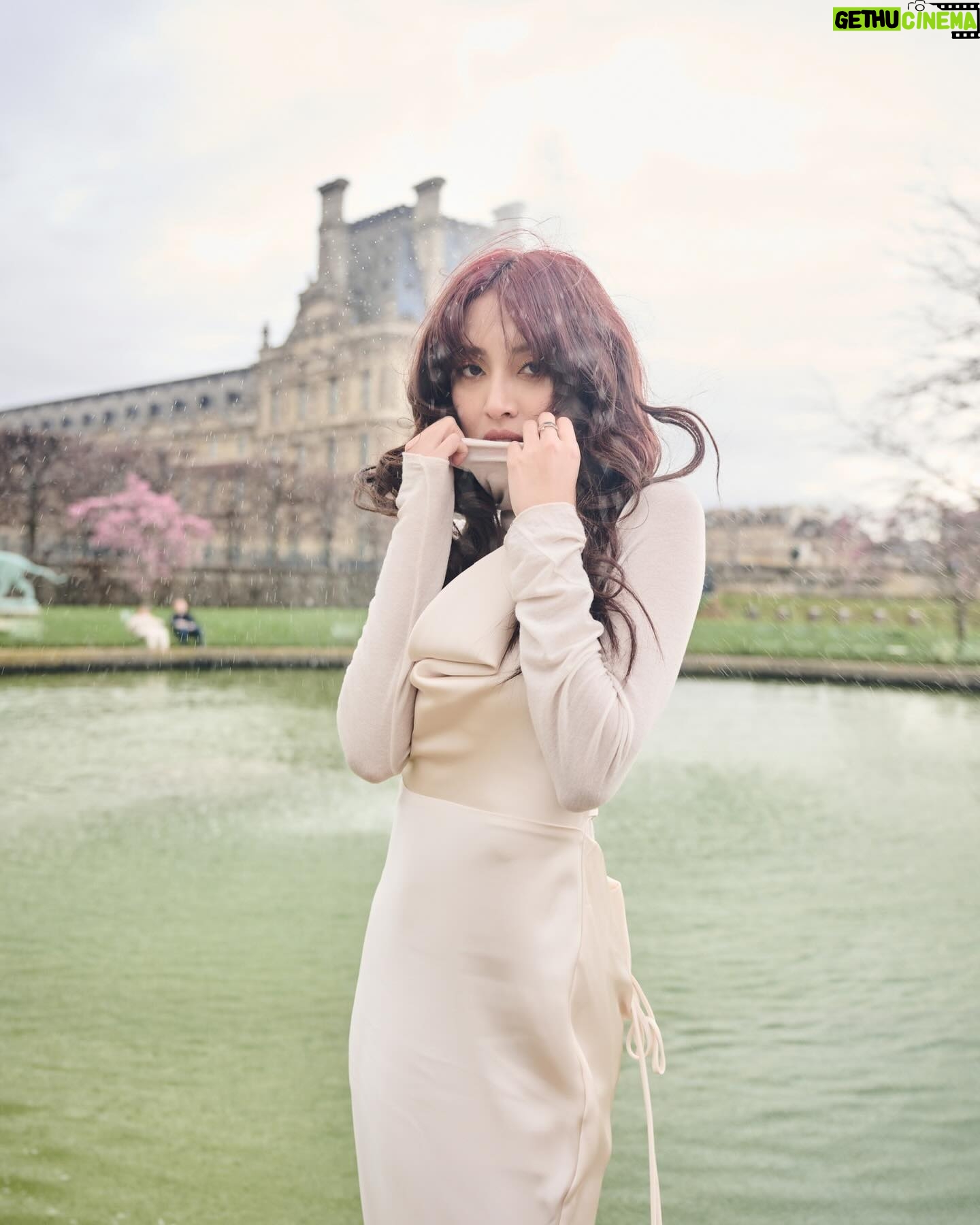 Grace Chan Instagram - The girl in a park in Paris. ⛲️ Before you think how uninspired this caption title is, here me out: The first time I went to Paris was when I was 10 or 11 with my family. It was one of those tour-guided trips —7 countries in 7 days around Europe— and guess what? I LOVED IT. I remember eating escargots for the first time I remember making up songs on the bus with my sister I also remember running through the park, surrounded by French colonial buildings…🤍🩷 And now so many years later, I’m back, but still that girl at heart. What’s your favorite Parisian memory?