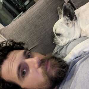 Henry Cavill Instagram - Today marks one year since Meat (our french bulldog) decided to shuffle off this mortal plane and continue on his journey. I have to say, I hadn't previously felt pain quite like the pain I felt when Meat died. I'd only know him for three years, but in those three years he and I made such incredible progress together, and he completely changed my outlook on French Bulldogs. He was deaf, so I learned how to use body language to communicate properly with him. He couldn't stand other dogs, but we got to a place of tolerance with Kal (my Akita). He survived a very complicated cancer removal surgery. He travelled to far flung lands without complaint. He would come looking for me at night if I stayed up playing computer games too late. He would be ferociously protective over Natalie, but learned to trust Kal and me for guidance. He fell ill and recovered a number of times. He enjoyed many a backpack ride once he got too tired to make any decent length walks. At the end he fell ill with a pneumonia. I'll never forget the expression on his face, desperately asking me for help on the way to the vet in Turkey because he couldn't breath. Once there, however, he held strong and recovered to such a point that we felt hope, but it turns out he was just waiting for us to bring him home. He passed away peacefully in England. Thinking of him always brings great sadness, but also great joy. We'll miss him as long as we live, but wouldn't live nearly as richly had we never have known him. Journey well Meatboi.