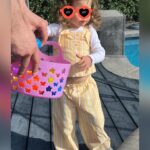 Iliza Shlesinger Instagram - We are Jewish but Sierra’s LA Grandma isn’t which means she gets Easter (and an Easter basket! I’m so jealous 🤍) and we all get Christmas. We filled eggs with Easter “candy” like… raisins and cashews and dried peaches and she had the best time. We did the neighborhood egg hunt too but she didn’t eat the chocolate because Mommy, who never lies, told her it was too spicy. Highlight for me was her holding this little blue bunny so delicately like it was a baby. Nothing will beat last year’s Easter outfit (last slide) but this one came close. 🐣🐰